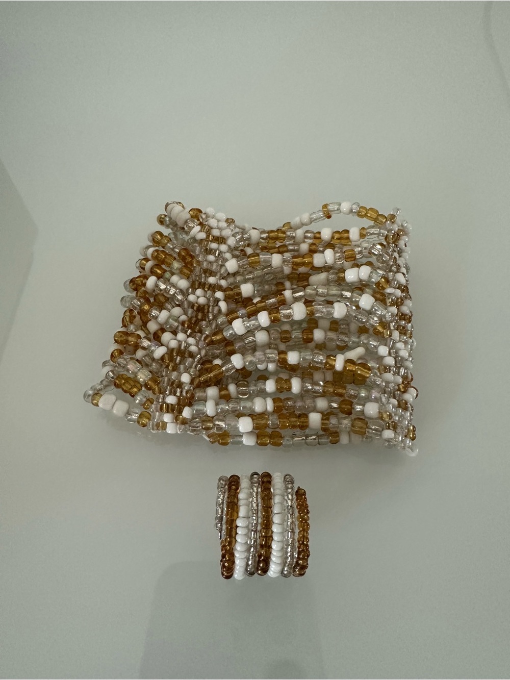 Set of bracelet and ring made of white and yellow beads, new without tag.